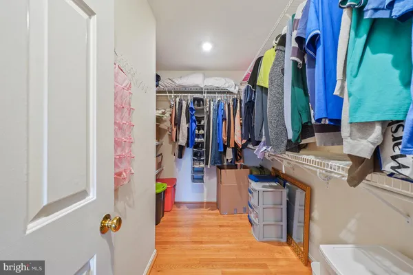 a view of walk in closet with clothes