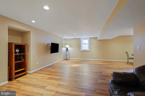 a view of empty room with wooden floor and cabinet