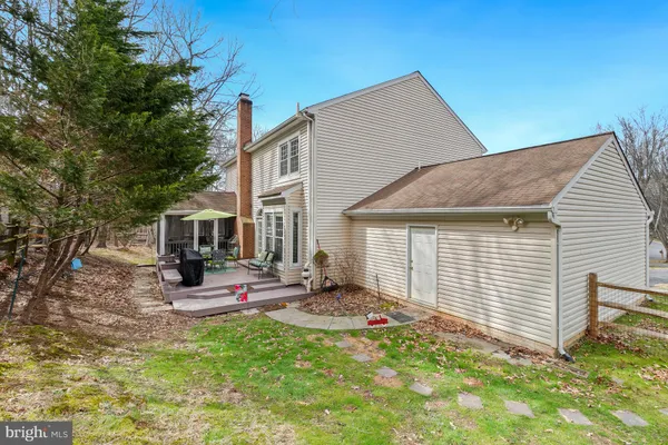 a view of a house with backyard porch and sitting area