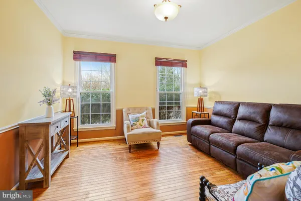 a living room with furniture window and wooden floor