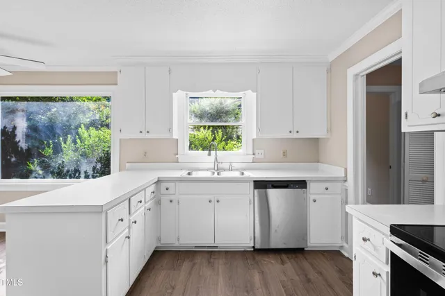 a kitchen with stove top oven and cabinets
