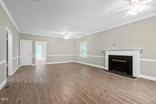 a kitchen with a white cabinets and window