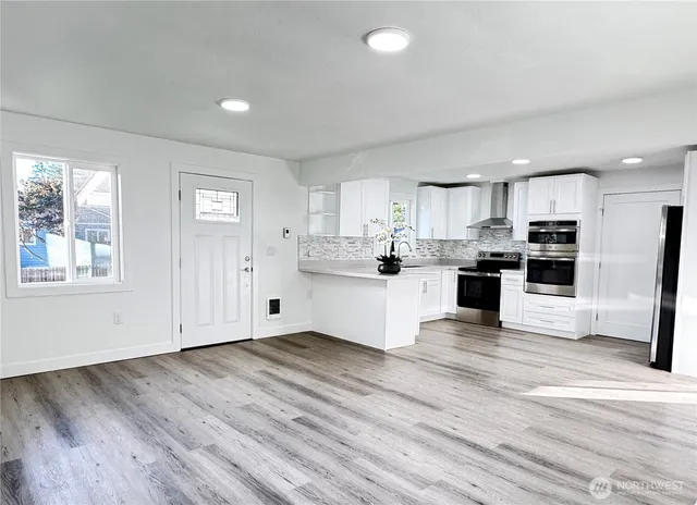 a view of kitchen with wooden floor and window