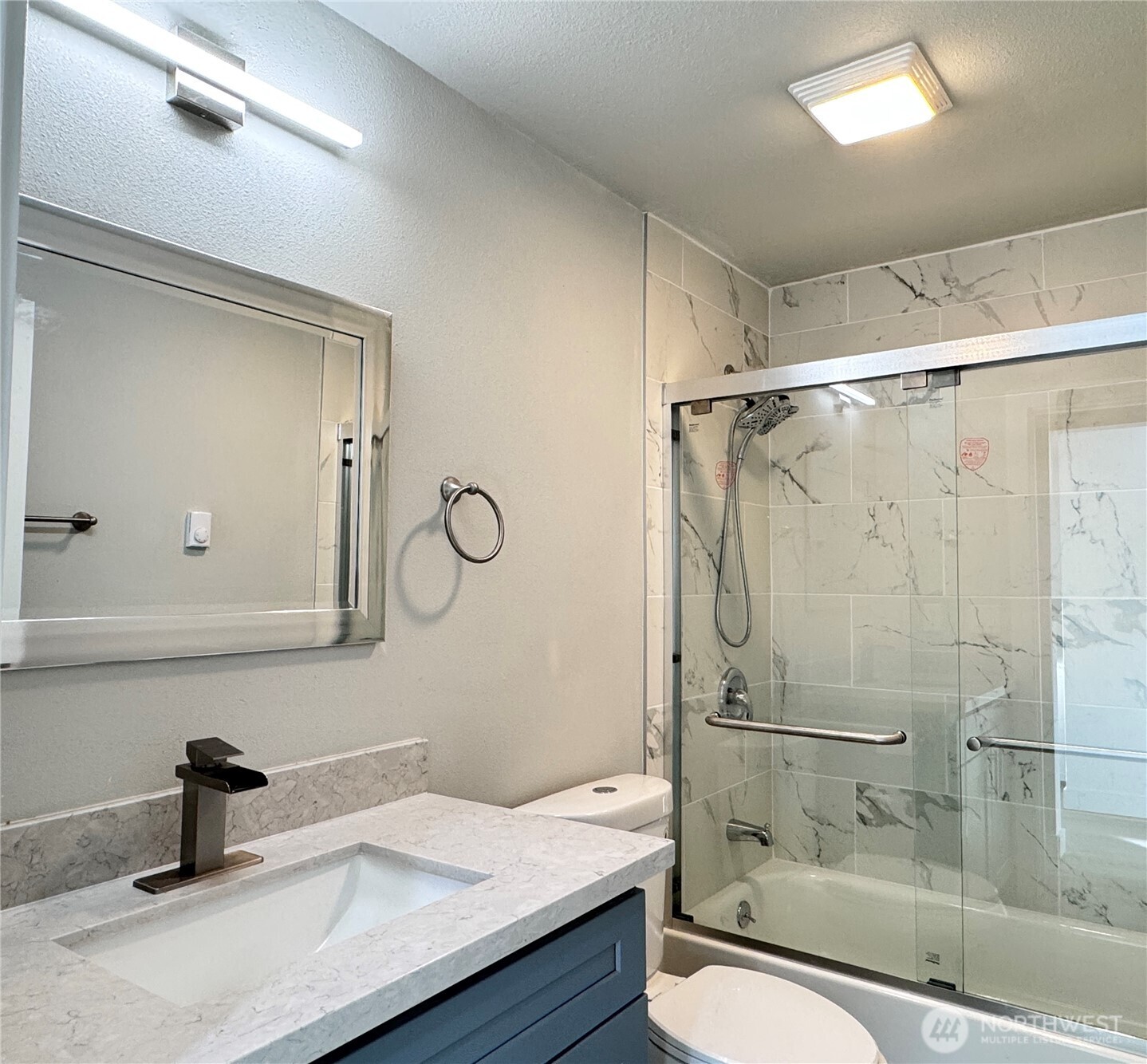 213 Willow Street Bremerton, WA 98310 - Photo 11 of 29 a bathroom with a granite countertop sink a toilet and shower