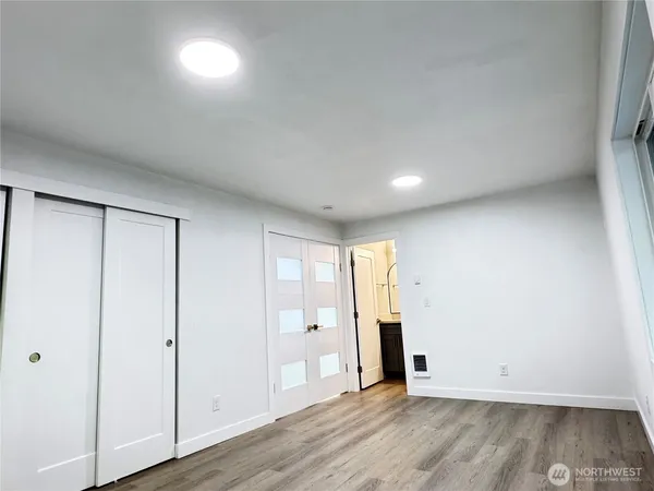 a view of an empty room with wooden floor