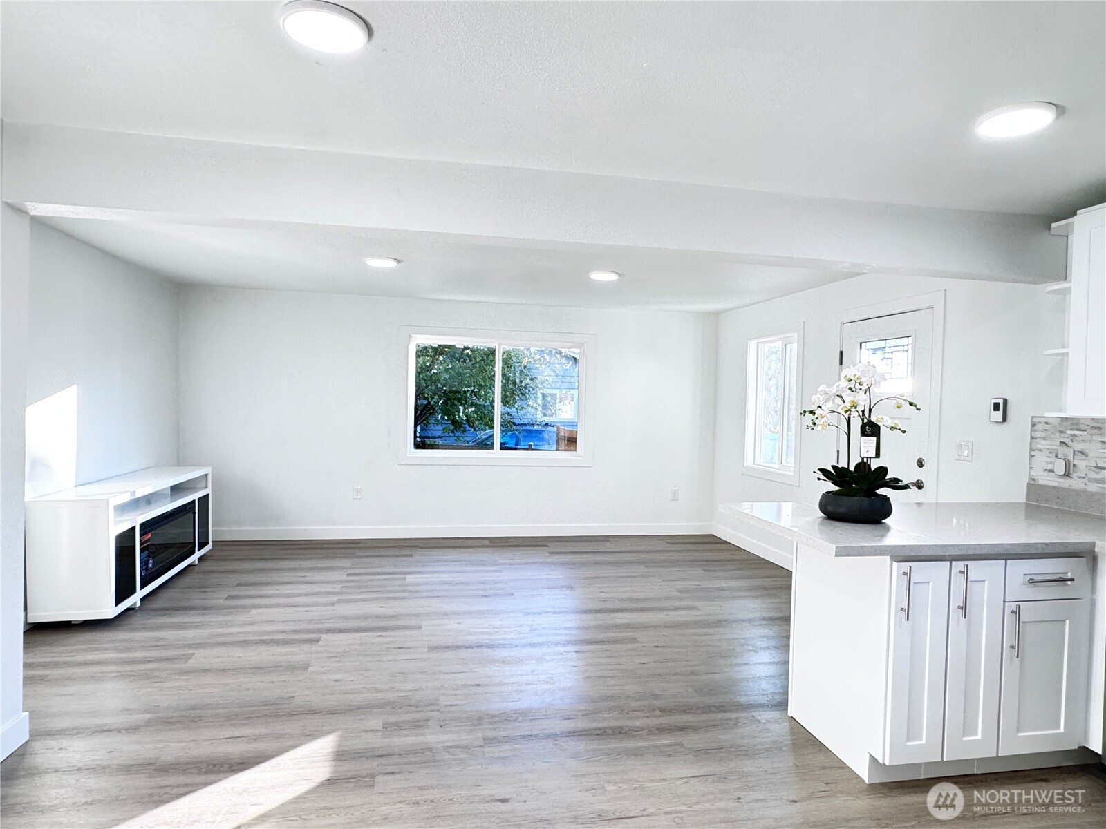213 Willow Street Bremerton, WA 98310 - Photo 6 of 29 an empty room with wooden floor and windows