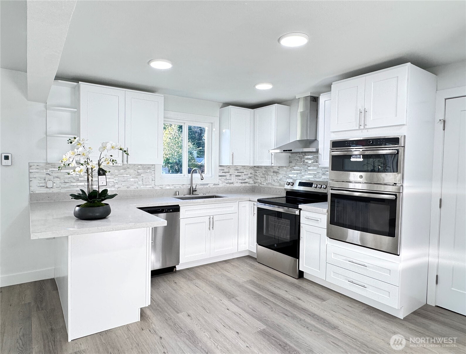 213 Willow Street Bremerton, WA 98310 - Photo 7 of 29 a kitchen with a sink white cabinets and white appliances