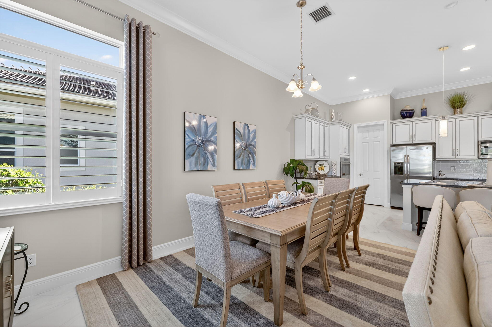 10619 Southwest Capraia Way Port St. Lucie, FL 34986 - Photo 15 of 90 a view of a dining room with furniture window and wooden floor