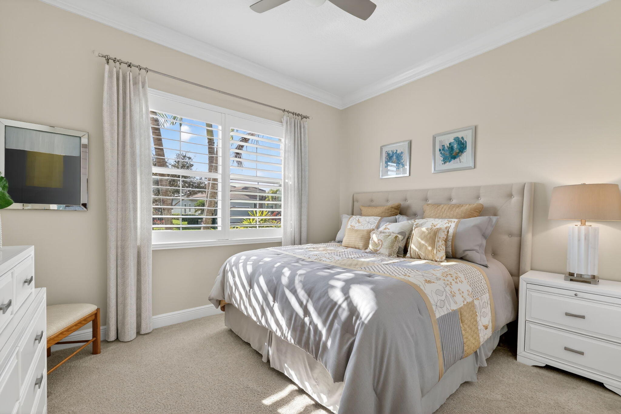 10619 Southwest Capraia Way Port St. Lucie, FL 34986 - Photo 27 of 90 a bedroom with a bed and a flat tv screen in it