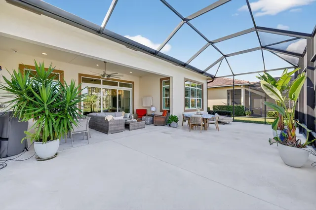 a dining room with wooden floor a chandelier a wooden table and chairs