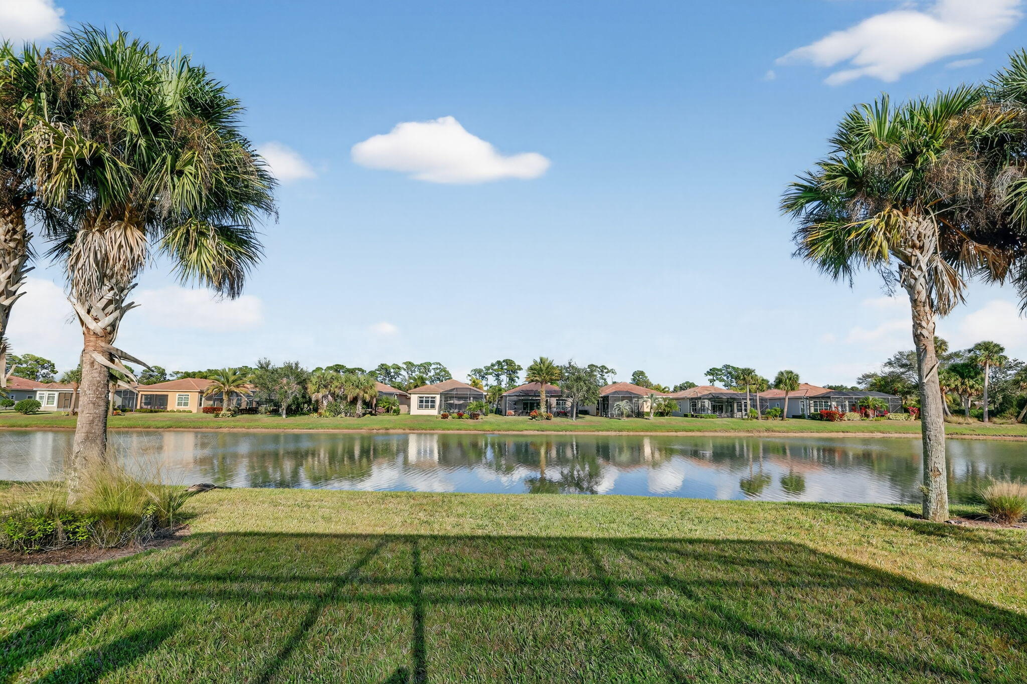 10619 Southwest Capraia Way Port St. Lucie, FL 34986 - Photo 45 of 90 a view of a lake with houses in the background