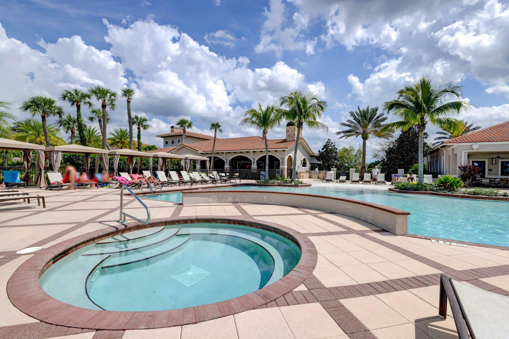 10619 Southwest Capraia Way Port St. Lucie, FL 34986 - Photo 69 of 90 a swimming pool with outdoor seating and lots of trees in the background