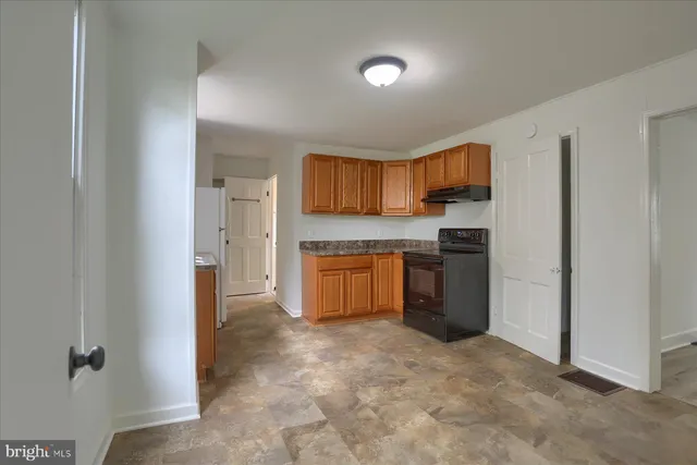 a kitchen with a stove top oven sink and a refrigerator