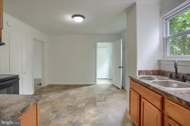a kitchen with granite countertop a sink and a granite top oven