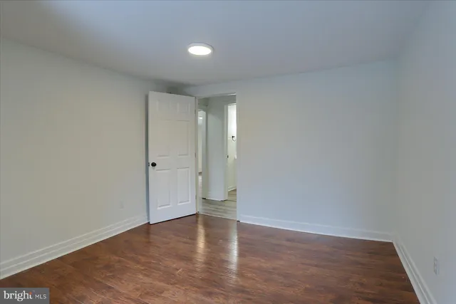 a view of an empty room and wooden floor