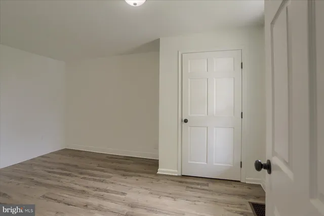 a view of room with wooden floor