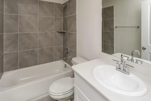 a bathroom with a sink toilet and bathtub