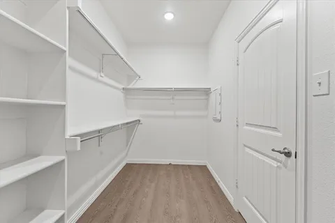 a bathroom with a double vanity sink a mirror and a bathtub