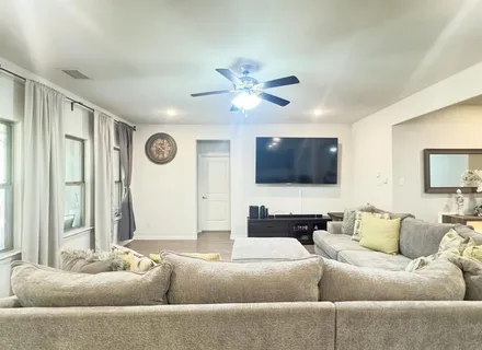 a large kitchen with stainless steel appliances lots of counter top space and wooden floor