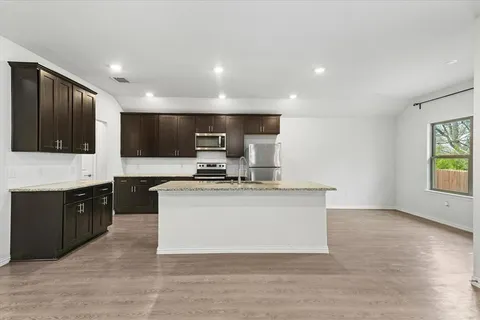a kitchen with stainless steel appliances a sink stove and microwave
