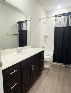 a living room with kitchen island furniture and a chandelier