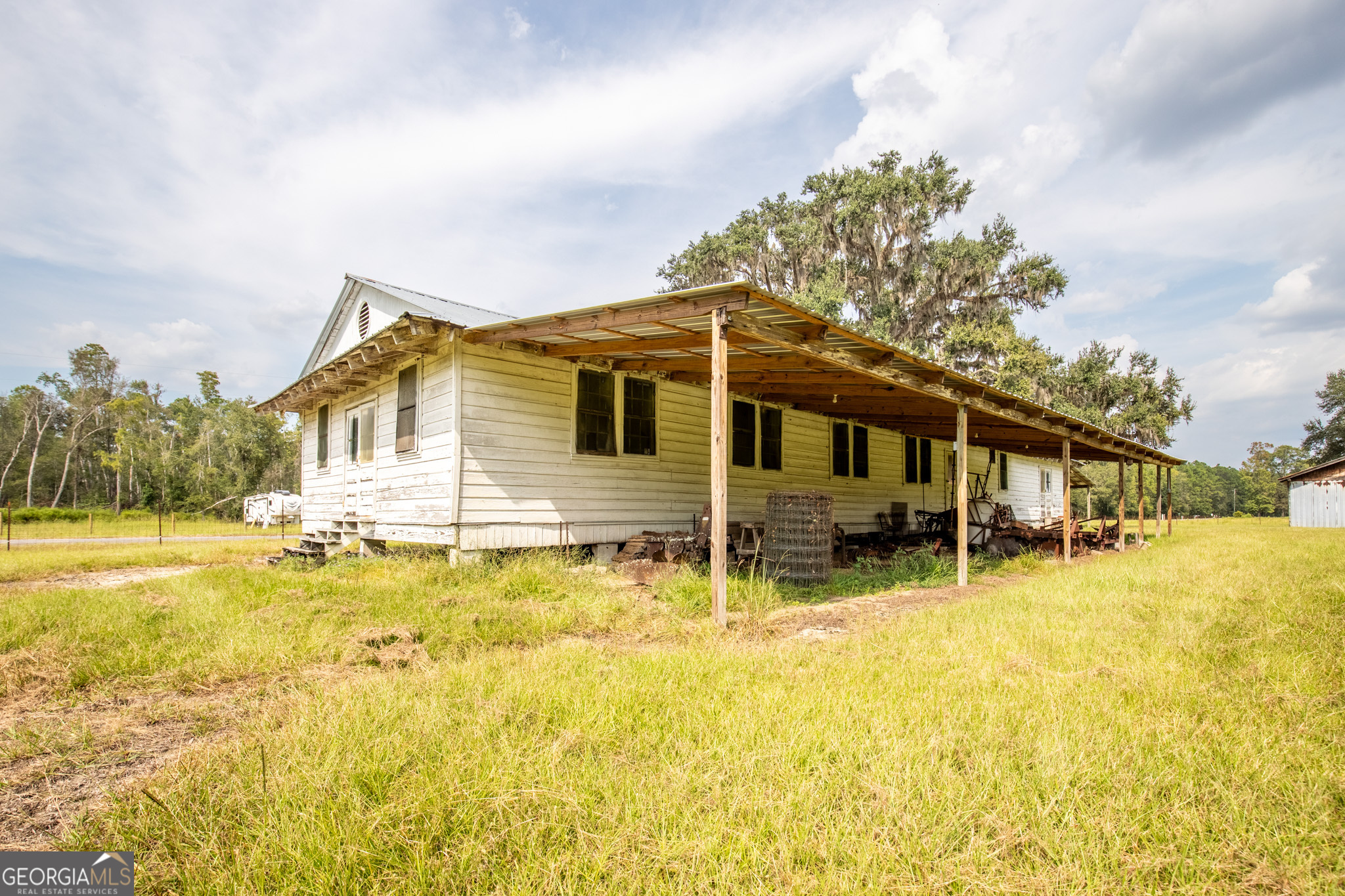 30-acres Hodges Road Hinesville, GA 31313 - Photo 29 of 34 a backyard of a house with swimming pool and brick wall