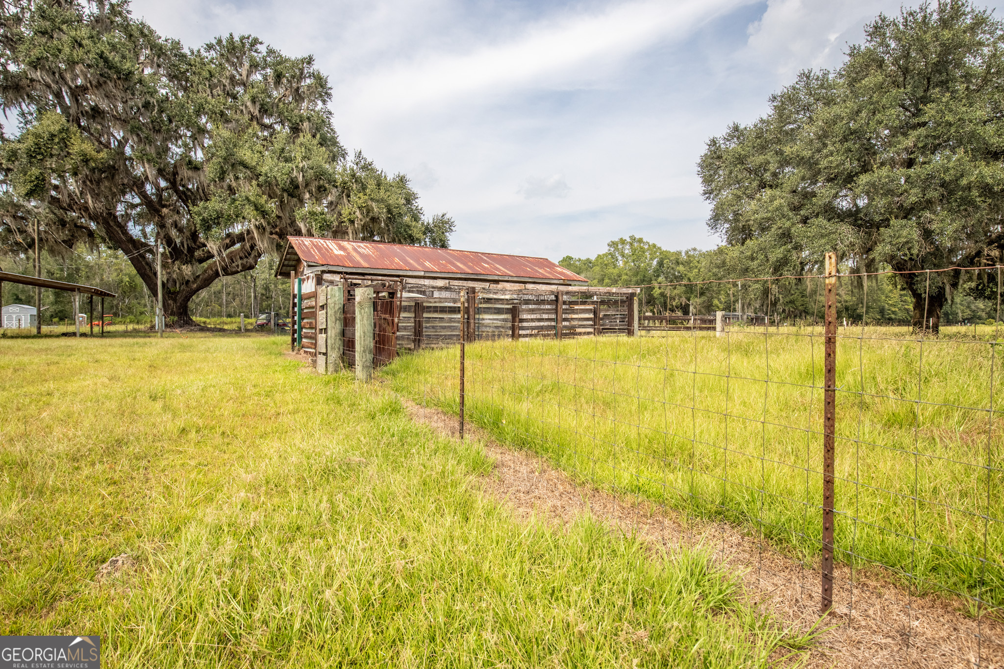 30-acres Hodges Road Hinesville, GA 31313 - Photo 31 of 34 a swimming pool that has lawn chairs under an umbrella