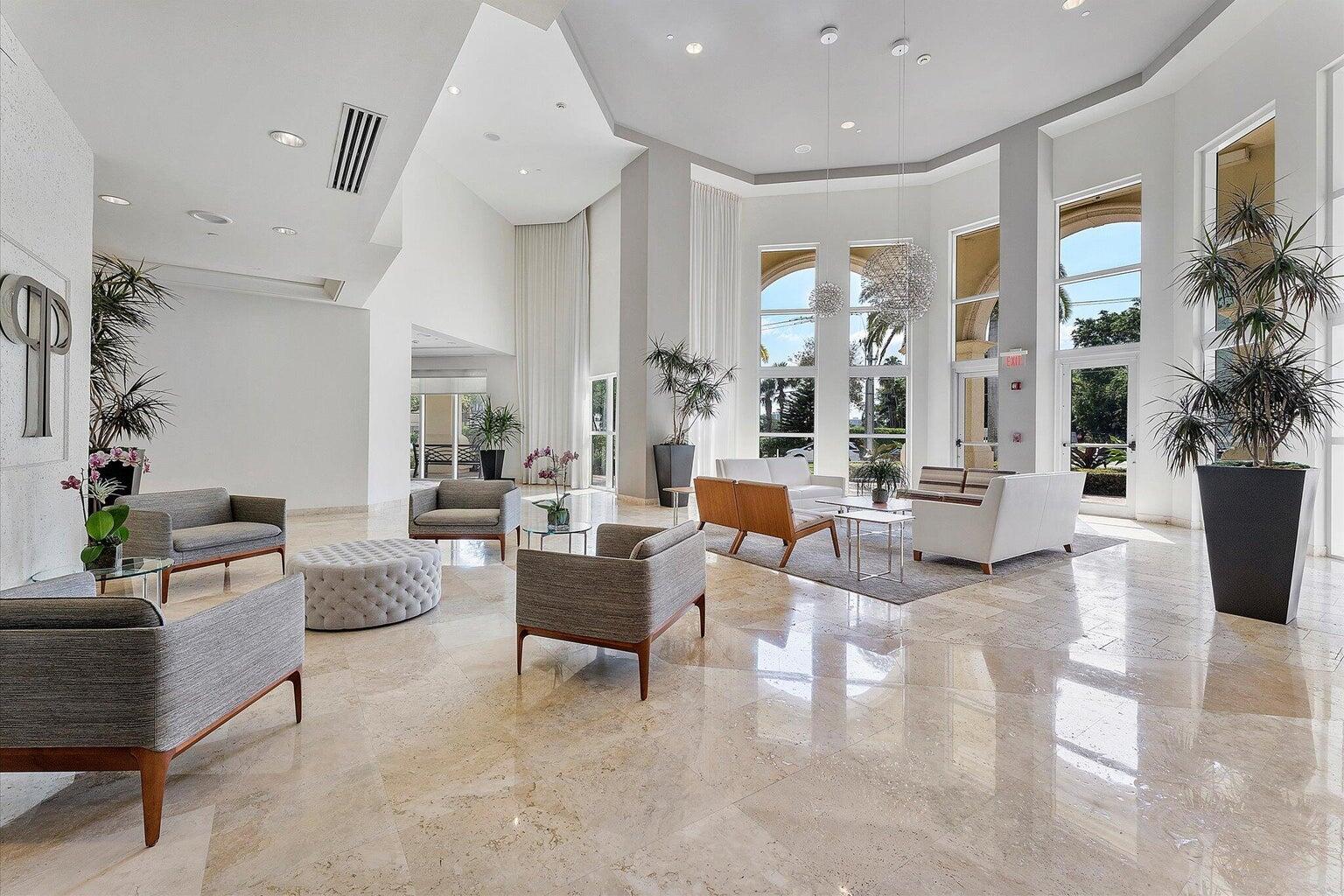 99 Southeast Mizner Boulevard, Unit 648 Boca Raton, FL 33432 - Photo 17 of 19 a living room with furniture and a large window
