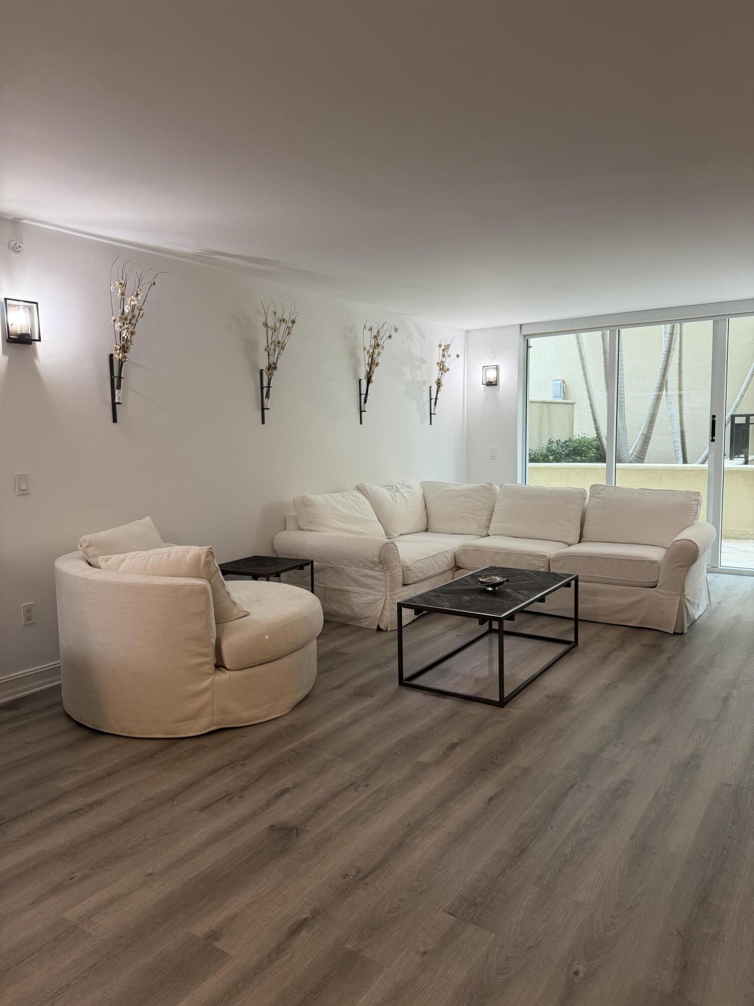 99 Southeast Mizner Boulevard, Unit 648 Boca Raton, FL 33432 - Photo 5 of 19 a living room with furniture and a large window