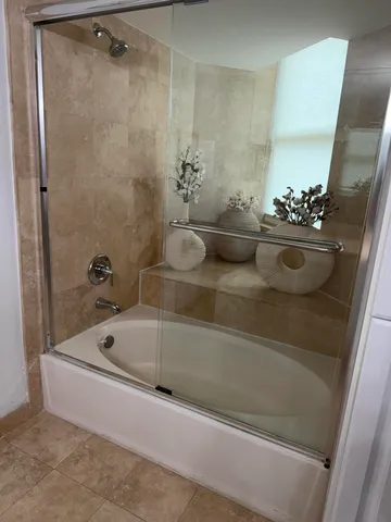 a bath tub sitting next to a bathroom sink