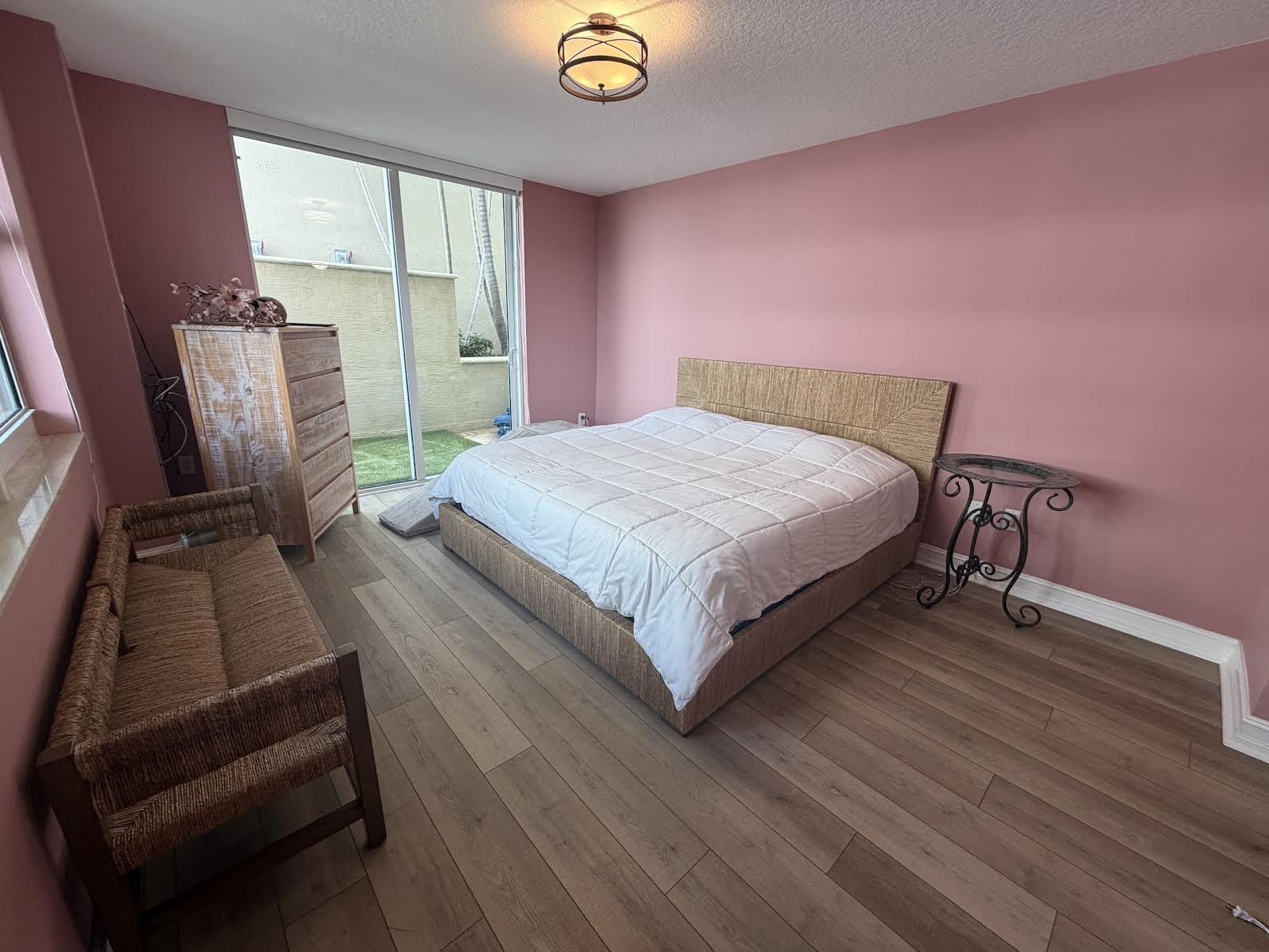 99 Southeast Mizner Boulevard, Unit 648 Boca Raton, FL 33432 - Photo 9 of 19 a bedroom with a bed dresser and a large window