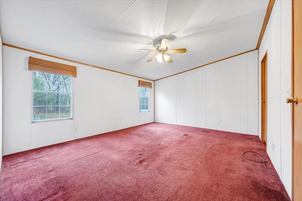 2492 Foster Road Thaxton, VA 24174 - Photo 6 of 34 an empty room with a window and a fan