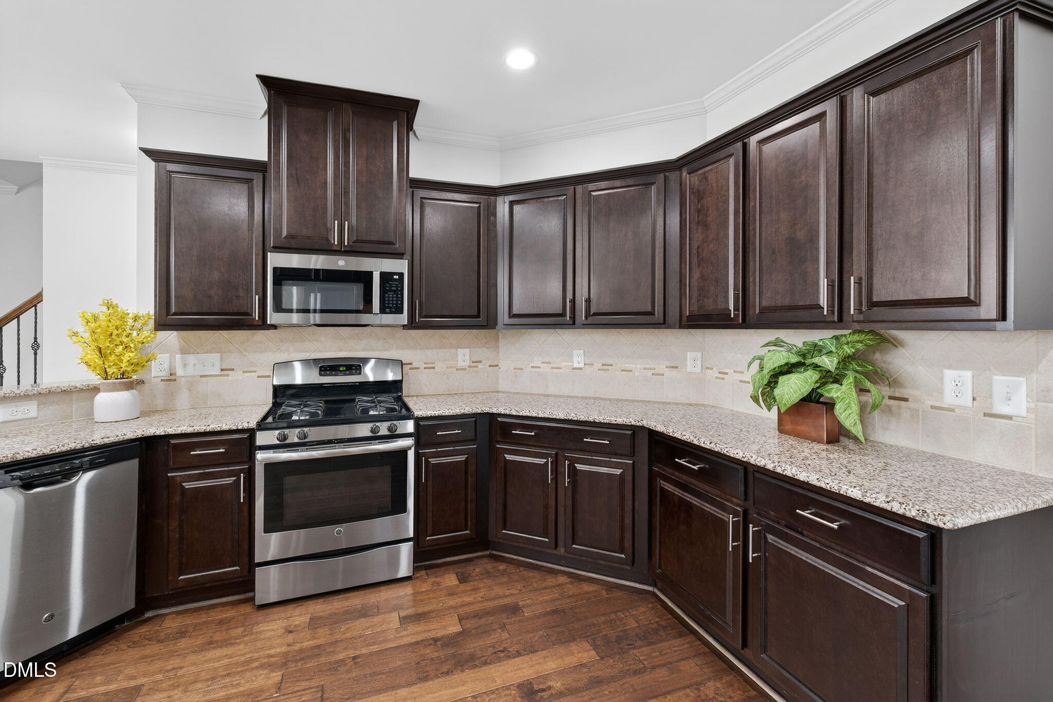 4033 Robious Court Cary, NC 27519 - Photo 15 of 58 a kitchen with stainless steel appliances granite countertop wooden cabinets a stove top oven a sink and dishwasher