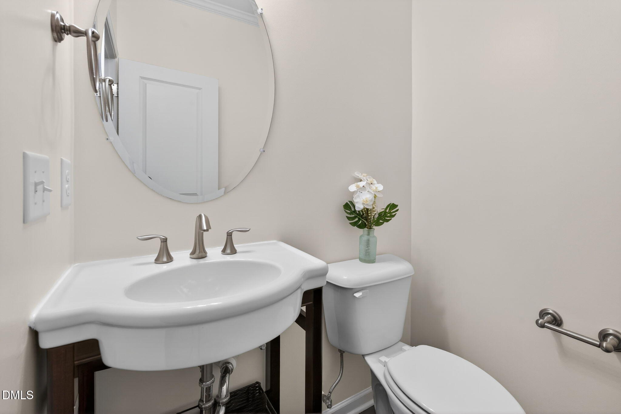 4033 Robious Court Cary, NC 27519 - Photo 18 of 58 a bathroom with a toilet a sink and a mirror