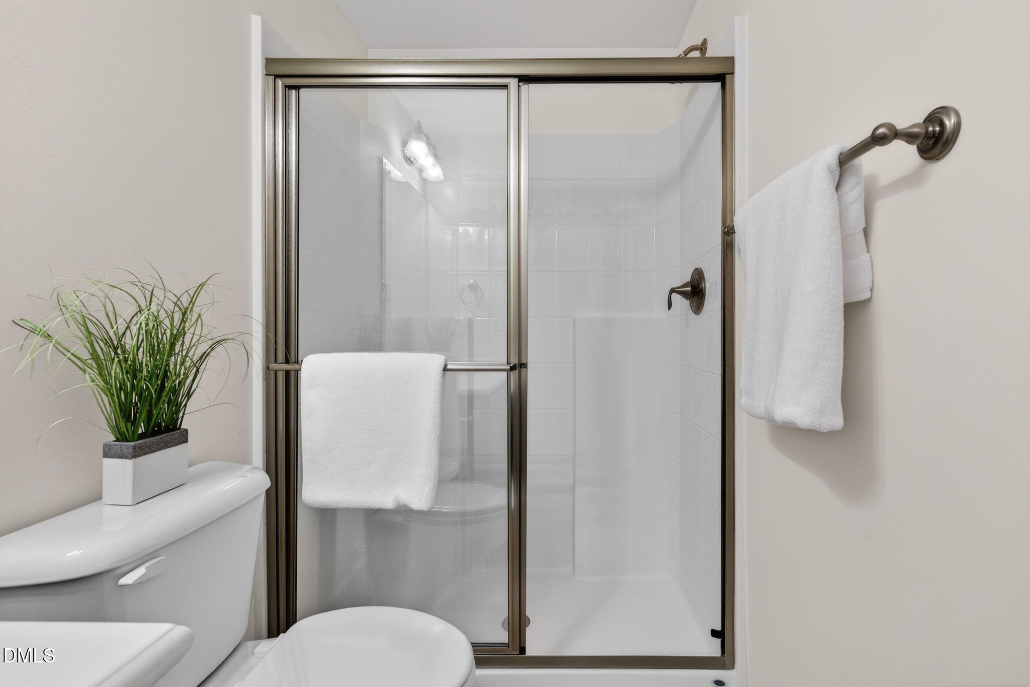 4033 Robious Court Cary, NC 27519 - Photo 40 of 58 a bathroom with a glass shower door