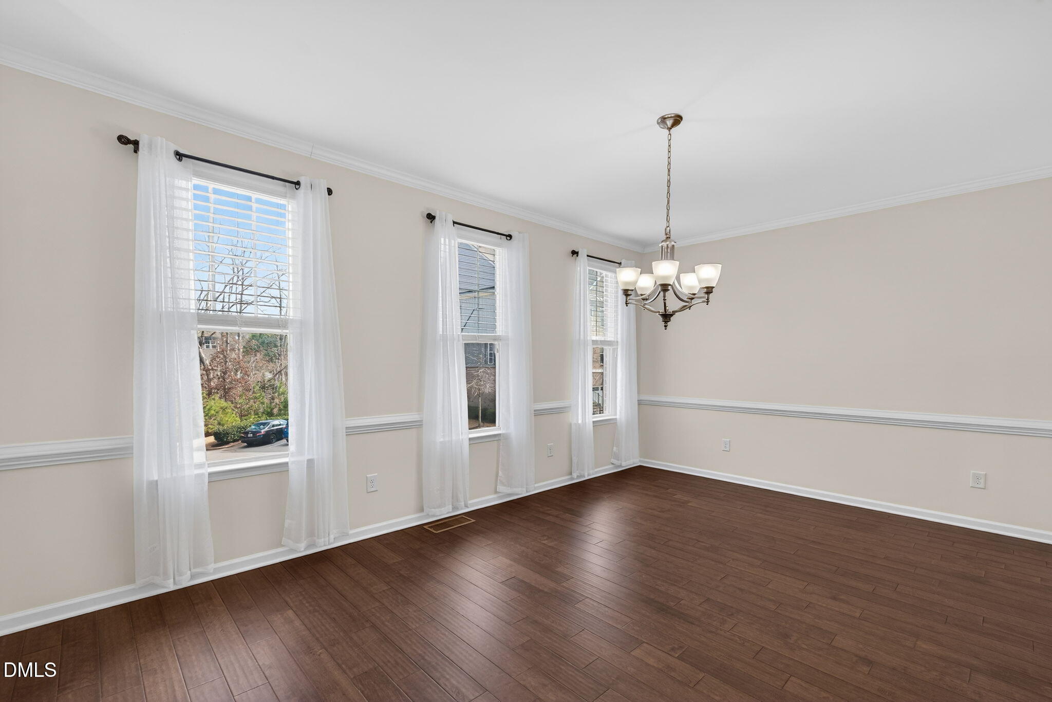 4033 Robious Court Cary, NC 27519 - Photo 9 of 58 a view of a room with wooden floor chandelier and windows