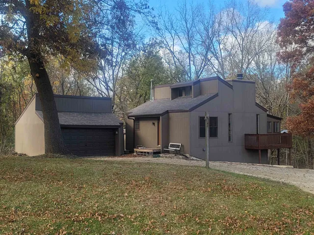 a house that has a tree in front of it