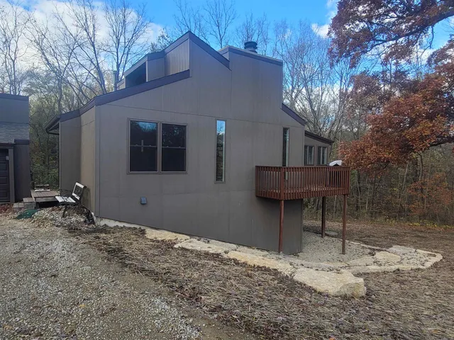 a backyard of a house with table and chairs