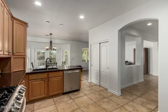 a kitchen with granite countertop a sink and cabinets