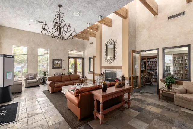 a living room with furniture a chandelier a fireplace and a chandelier