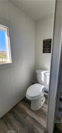 a bathroom with a toilet sink and window