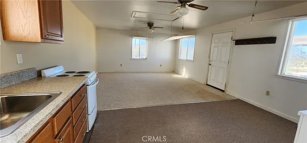 a kitchen with stainless steel appliances granite countertop a sink a stove and a refrigerator