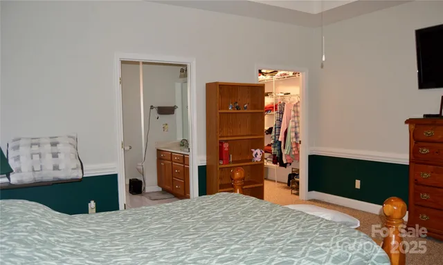 a bedroom with a bed and a television