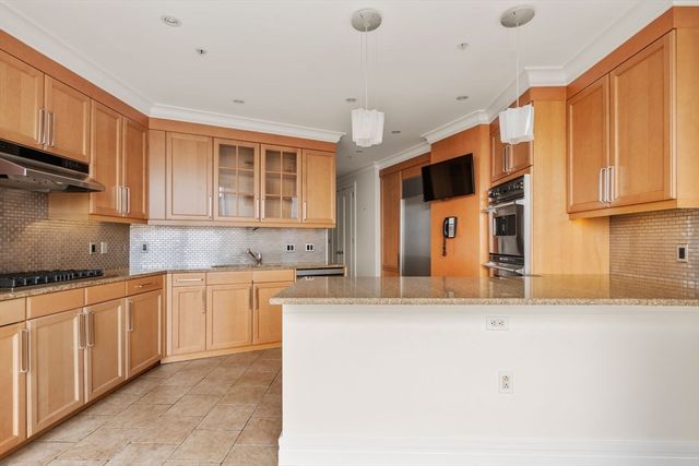 a kitchen with stainless steel appliances granite countertop a stove and a sink