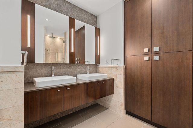 a bathroom with a double vanity sink and mirror