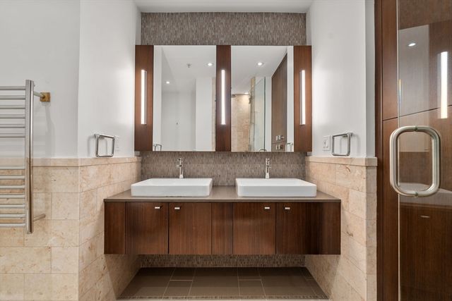 a bathroom with a double vanity sink and a mirror