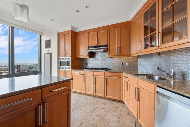 a kitchen with stainless steel appliances granite countertop a sink and cabinets
