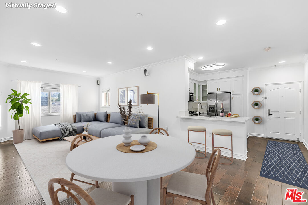 a living room with furniture kitchen view and a table