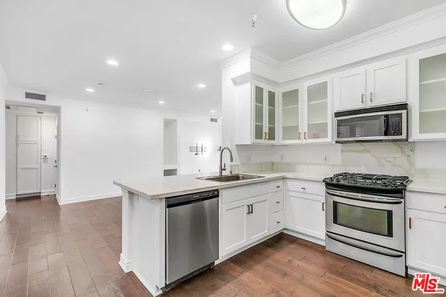 an empty room with wooden floor and a window