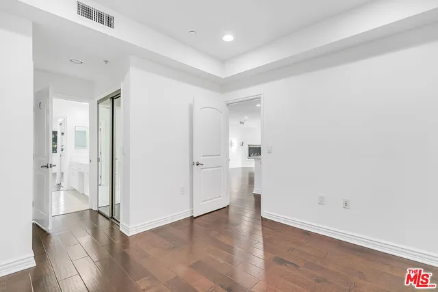 a spacious bathroom with a double vanity sink and a mirror